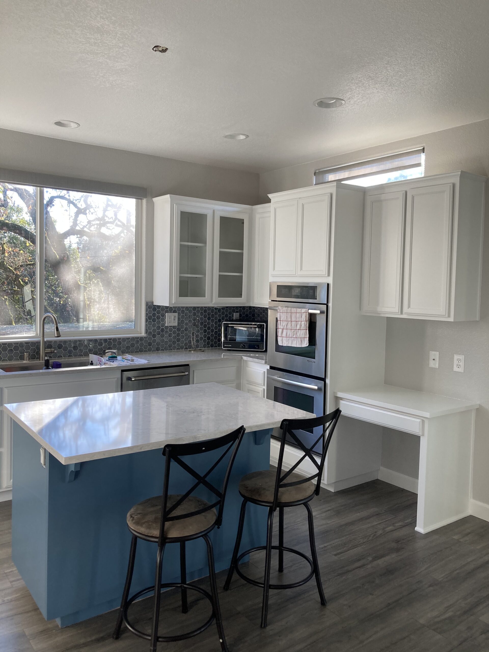 modern kitchen with blue center island and colorful appliances