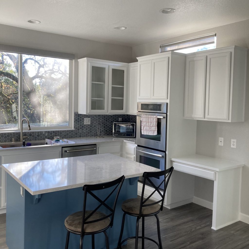 modern kitchen with blue center island and colorful appliances