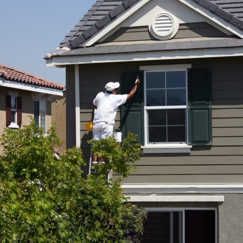 a man painting commercial housing