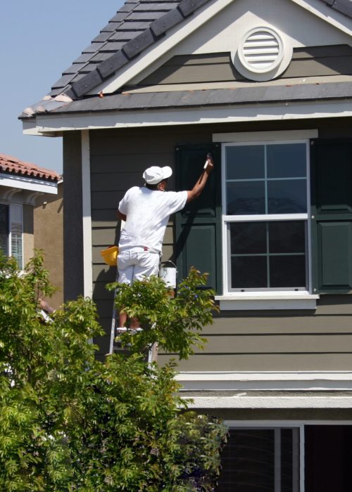 a man painting commercial housing