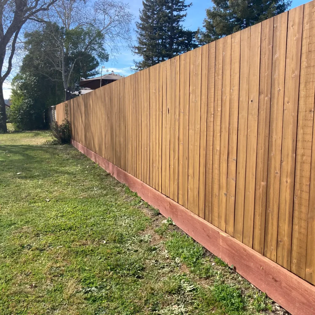 Wooden backyard fence on a sunny day.