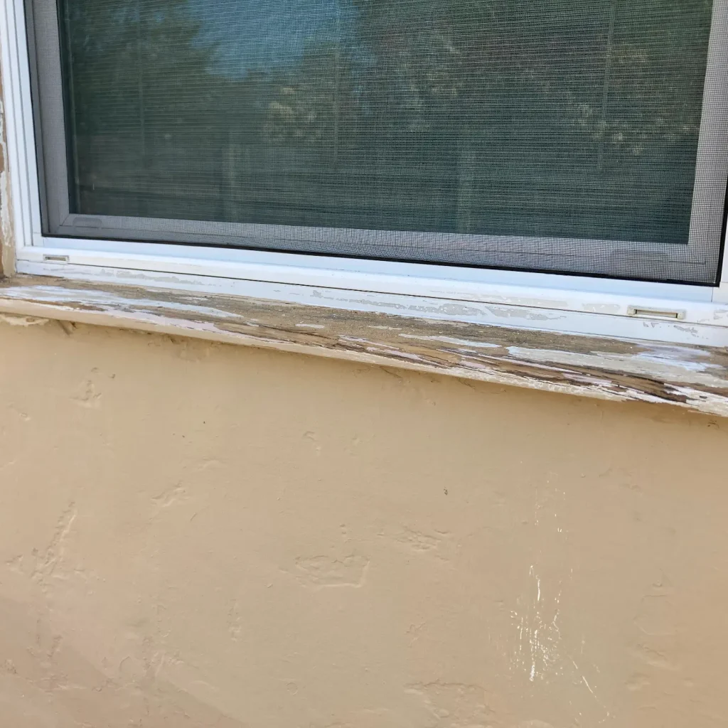 Weathered window sill needing repair.